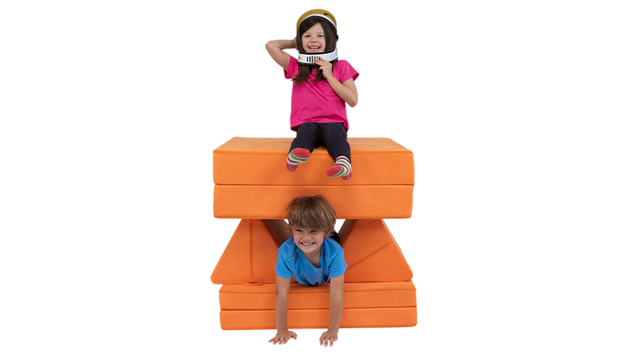 Two children blast off into pretend space aboard a one-Nugget spaceship build, made from an orange play couch.
