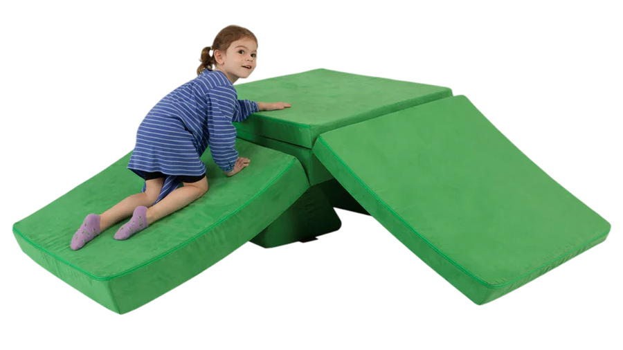 A child crawls up a one-Nugget slide build — created with a kelly green Nugget play couch. 