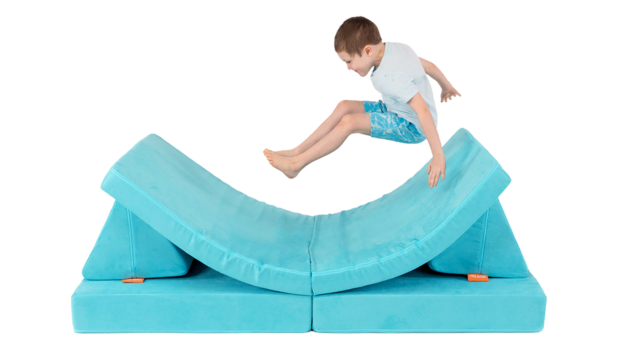 One child leaps onto a one-Nugget hammock build, made from a turquoise Nugget play couch.  