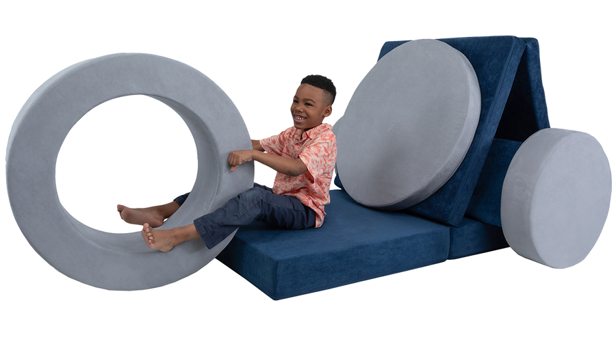 A child engages his imagination to pretend a Nugget and Chunk are a giant tricycle or motorcycle.