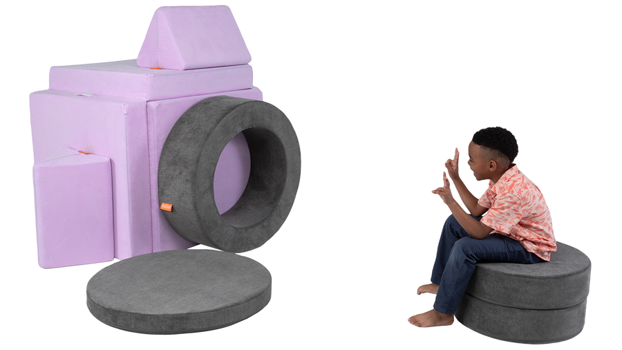 A child uses one Nugget, one Chunk, and his imagination to pretend he’s posing for a life-sized camera lens.
