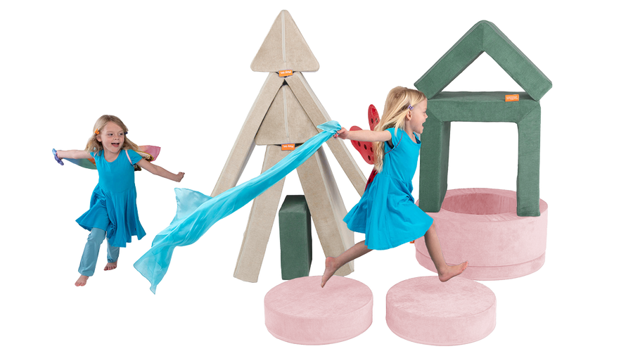 Two children run around an elaborate obstacle course built from a Nugget play couch, Chunk play ottoman, and Smore play chair.