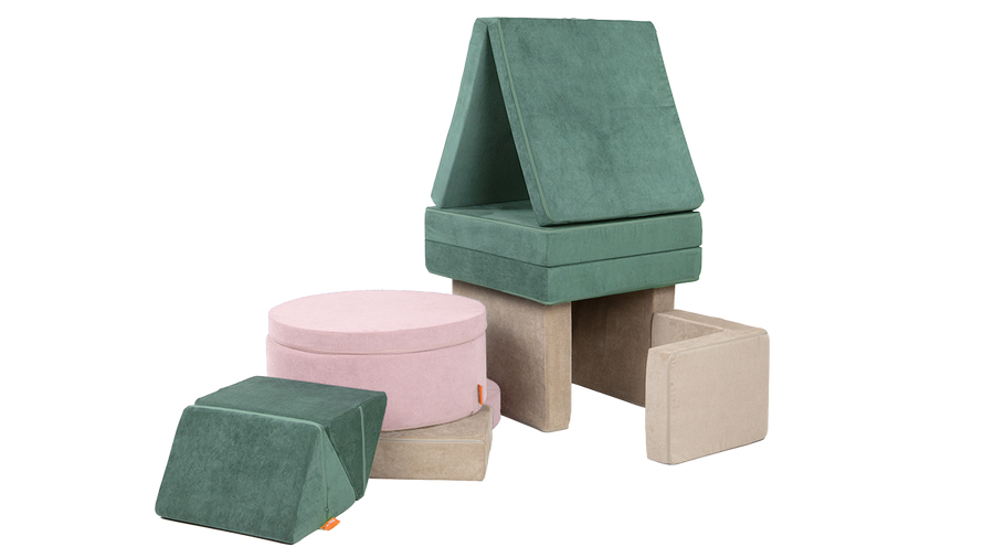 An interconnected playscape is arranged from the pieces of a sea green Nugget, blush pink Chunk, and beige Smore.
