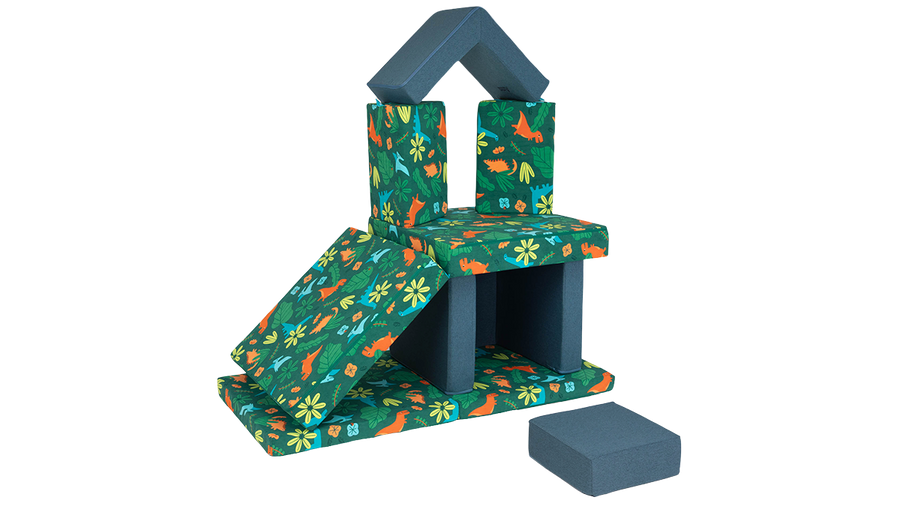 A Smore play chair and Nugget play couch are combined to create a tall fort with a slide, cozy nook, and second floor.