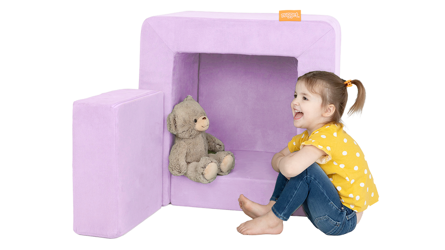 A child plays with a stuffed animal, perched in the pieces of a lavender purple Smore play chair.