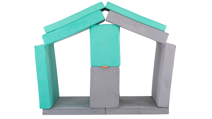 Two Nugget play couches are arranged in a stable build with stalls for pretend horses, ready for imaginative play.