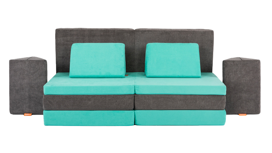 Two Nugget play couches are set up as a high-couch build, with the cushions arranged as an elevated platform with side tables.