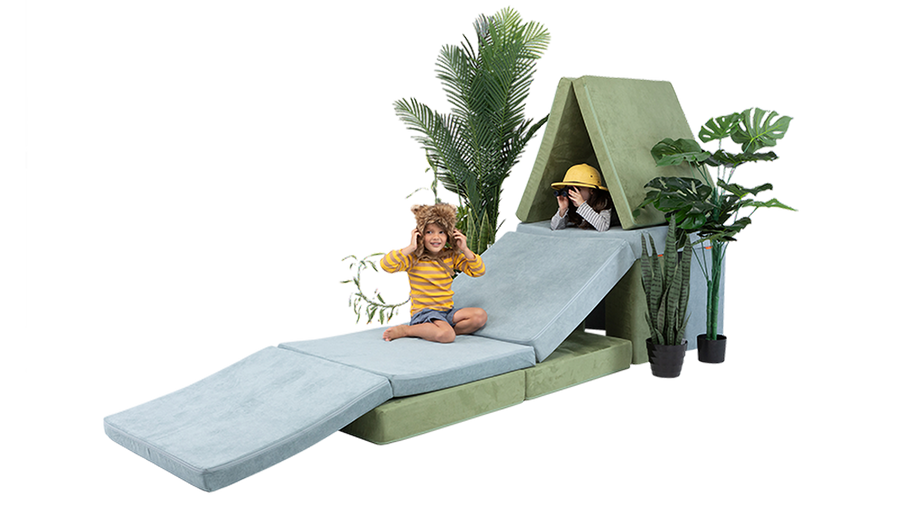 Two children play inside a treehouse build, constructed using two Nugget play couches. 