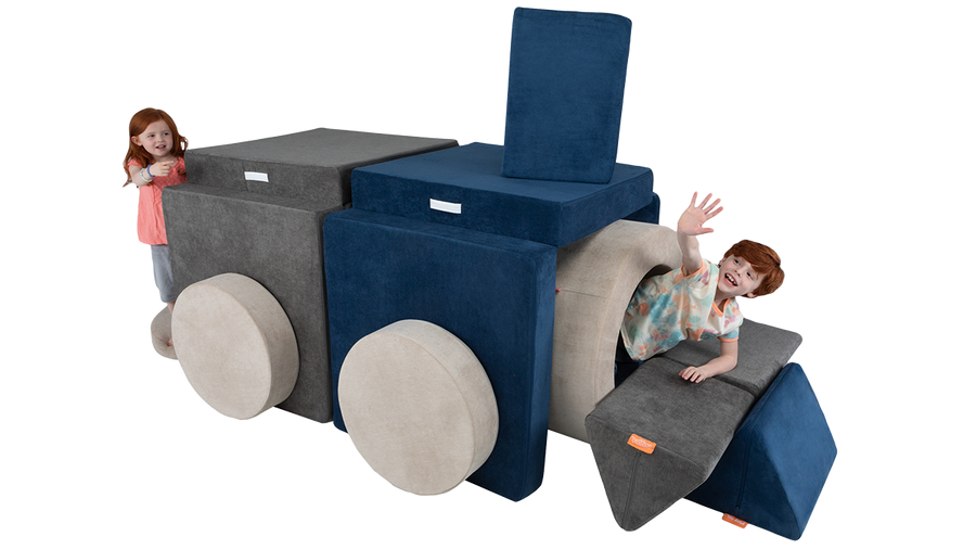Two kids hide and play inside a cool Nugget fort tunnel constructed with two Nuggets and one Chunk play ottoman. 
