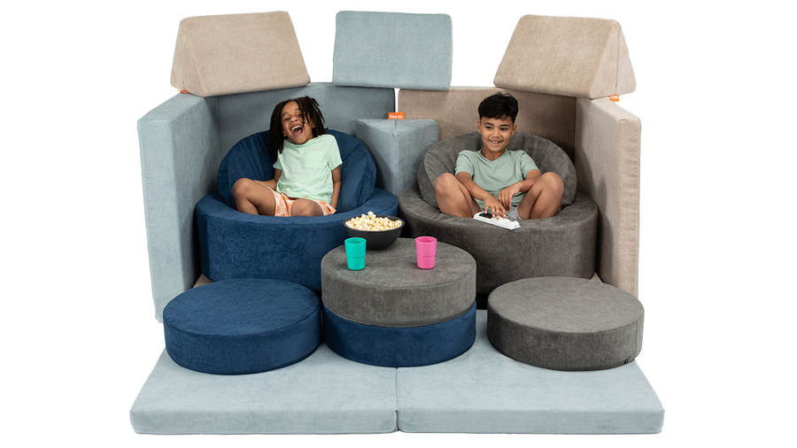 Two children eat popcorn and cozy up for a movie using theatre seating made from two Nuggets and two Chunks.