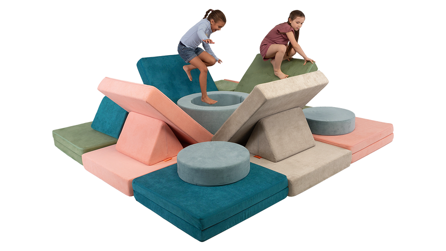 Two kids jump and play inside a cool Nugget fort constructed with four Nuggets and one Chunk play ottoman. 