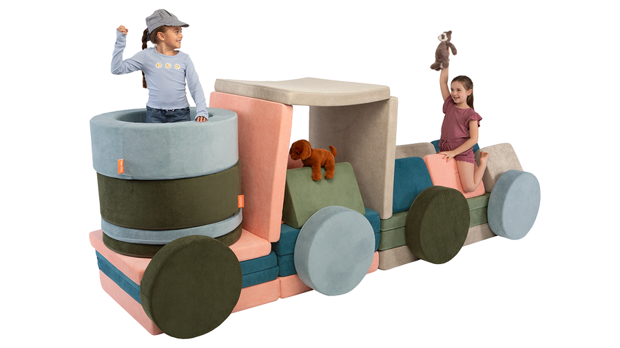 Two kids play with stuffed animals inside an imaginative play furniture train engine, made of four Nuggets and two Chunks.