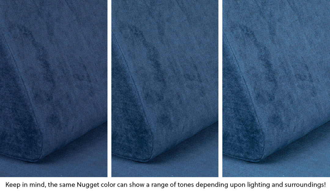 Close-up of a Nugget pillow in Blueridge navy blue across three lighting situations. One color can present as a range of tones depending on the room.