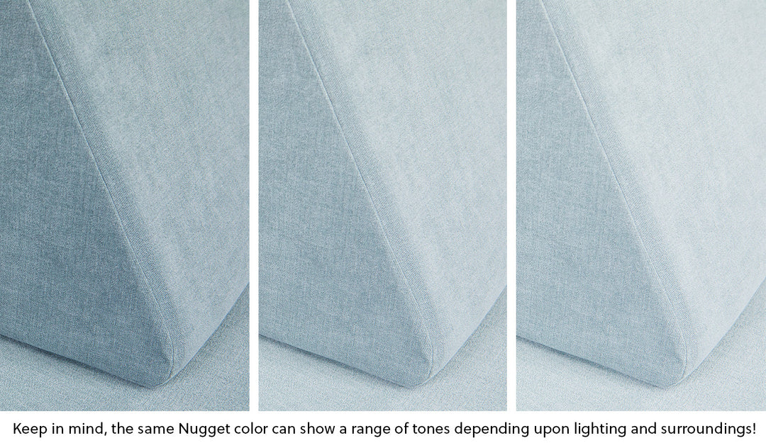 Close-up of a Nugget pillow in Surfside light gray-blue across three lighting situations. One color can present as a range of tones depending on the room.